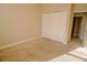 Bedroom with neutral carpeting, closet, and doorway at 1355 Misty Glen Ln, Clermont, FL 34711