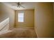 Neutral bedroom featuring a ceiling fan and natural light from the window at 1355 Misty Glen Ln, Clermont, FL 34711