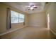 Light-filled bedroom featuring tile floors, a tray ceiling, a window, and neutral paint at 1355 Misty Glen Ln, Clermont, FL 34711
