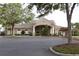 Elegant clubhouse featuring well-manicured landscaping, ample parking, and a welcoming entrance at 1355 Misty Glen Ln, Clermont, FL 34711
