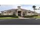 Inviting clubhouse featuring a Grille Tavern and Pro Shop, with a well-maintained exterior and landscaping at 1355 Misty Glen Ln, Clermont, FL 34711