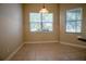 Bright dining area features tile flooring, neutral walls, and large windows with natural light and neighborhood views at 1355 Misty Glen Ln, Clermont, FL 34711