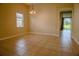 Bright dining room boasts neutral paint, tile flooring, and natural light, offering a versatile living space at 1355 Misty Glen Ln, Clermont, FL 34711