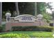 Elegant stone entrance sign for Legends Golf Club, surrounded by well-maintained landscaping and lush greenery at 1355 Misty Glen Ln, Clermont, FL 34711