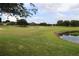 Expansive golf course view, highlighting the manicured lawns and landscaping within the community at 1355 Misty Glen Ln, Clermont, FL 34711