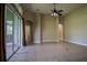 Spacious living area with tile flooring, ceiling fan, and sliding glass doors at 1355 Misty Glen Ln, Clermont, FL 34711