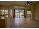 Bright, open living space with tile floors, ceiling fan, and sliding glass doors to a backyard view at 1355 Misty Glen Ln, Clermont, FL 34711