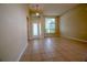 Spacious living room features neutral paint, tile flooring, and large windows that fill the space with natural light at 1355 Misty Glen Ln, Clermont, FL 34711