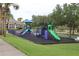Colorful community playground with multiple slides, climbing structures, and a safe, cushioned surface for enjoyment at 1355 Misty Glen Ln, Clermont, FL 34711