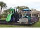 Community playground with slide, climbing equipment, and cushioned ground cover at 1355 Misty Glen Ln, Clermont, FL 34711