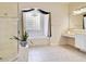 Bathroom featuring a walk-in shower, a separate soaking tub, and a vanity area at 1426 Lakemist Ln, Clermont, FL 34711