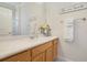 Bright bathroom with white countertop, white cabinets, and a decorative sign and towel rack at 1426 Lakemist Ln, Clermont, FL 34711