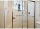 Bathroom features a glass-enclosed shower, tiled walls, a window with plant decor and built in seat at 1426 Lakemist Ln, Clermont, FL 34711