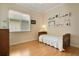 Serene bedroom with hardwood floors, a large window, and a charming display of Gathering photos at 1426 Lakemist Ln, Clermont, FL 34711