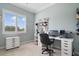 Bedroom setup with a computer desk, window with shutters, and office storage at 1426 Lakemist Ln, Clermont, FL 34711