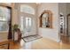 Inviting entryway with decorative front door, accent painting, and hardwood flooring at 1426 Lakemist Ln, Clermont, FL 34711