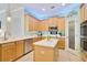 Well-equipped kitchen with wooden cabinets, stainless steel appliances, center island and a convenient pantry at 1426 Lakemist Ln, Clermont, FL 34711