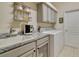 Functional laundry room with a sink, countertop, modern washer and dryer, and extra storage space at 1426 Lakemist Ln, Clermont, FL 34711