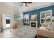 Living room with blue accent wall, a fireplace, and plenty of natural light from windows at 1426 Lakemist Ln, Clermont, FL 34711
