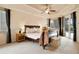 Comfortable main bedroom featuring tray ceilings, a ceiling fan, and access to the pool area at 1426 Lakemist Ln, Clermont, FL 34711