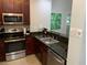 Well-equipped kitchen featuring a stainless steel oven, microwave, and stainless steel sink at 14501 Grove Resort Ave # 3406, Winter Garden, FL 34787