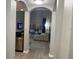 Comfortable view through a arched doorway into a beautifully furnished living room with patio access at 14501 Grove Resort Ave # 3406, Winter Garden, FL 34787