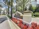 Entrance signage for The Grove Resort & Spa with flowers and palm trees at 14501 Grove Resort Ave # 3406, Winter Garden, FL 34787
