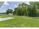 Picturesque backyard featuring lush green grass and mature trees at 14611 Se 95Th Ct, Summerfield, FL 34491