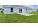 Backyard view of a home with a concrete patio and sliding glass doors at 14611 Se 95Th Ct, Summerfield, FL 34491