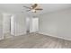 A bedroom with hardwood floors, ceiling fan, and closet at 14611 Se 95Th Ct, Summerfield, FL 34491