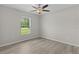 Comfortable bedroom featuring hardwood floors and a bright window at 14611 Se 95Th Ct, Summerfield, FL 34491