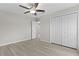 Bright bedroom with hardwood floors, fan, and a closet at 14611 Se 95Th Ct, Summerfield, FL 34491