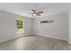 Bright bedroom featuring hardwood floors, windows, and a ceiling fan at 14611 Se 95Th Ct, Summerfield, FL 34491