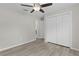 Bright bedroom with hardwood floors, closet, and a ceiling fan at 14611 Se 95Th Ct, Summerfield, FL 34491