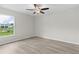 Cozy bedroom with hardwood floors and a large window at 14611 Se 95Th Ct, Summerfield, FL 34491