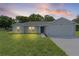 Attractive single-story home with an attached garage under a colorful evening sky at 14611 Se 95Th Ct, Summerfield, FL 34491