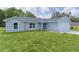 Charming single-story home featuring a lush green lawn and attached two-car garage at 14611 Se 95Th Ct, Summerfield, FL 34491