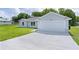 Single-story home with a two-car garage and extended driveway at 14611 Se 95Th Ct, Summerfield, FL 34491