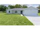Attractive single-story home with an attached garage and well-maintained lawn at 14611 Se 95Th Ct, Summerfield, FL 34491