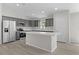 Beautiful kitchen with stainless steel appliances, gray cabinets, and a kitchen island at 14611 Se 95Th Ct, Summerfield, FL 34491