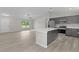 Kitchen with gray cabinetry, stainless appliances, and a breakfast bar at 14611 Se 95Th Ct, Summerfield, FL 34491