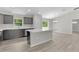 Modern kitchen boasts gray cabinets, stainless steel appliances, and a central island at 14611 Se 95Th Ct, Summerfield, FL 34491