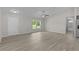 Open living room with vinyl flooring and large window for natural light at 14611 Se 95Th Ct, Summerfield, FL 34491