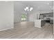 Open layout showing the kitchen with stainless appliances, living room and breakfast bar at 14611 Se 95Th Ct, Summerfield, FL 34491