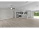 Open-concept living space featuring vinyl plank floors, stainless appliances, and a peninsula island at 14611 Se 95Th Ct, Summerfield, FL 34491