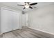 Bedroom featuring updated floors, a ceiling fan, and a closet with double doors at 14631 Se 95Th Ct, Summerfield, FL 34491