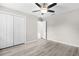 Bedroom featuring updated floors, a ceiling fan, and a closet with double doors at 14631 Se 95Th Ct, Summerfield, FL 34491