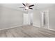 Bright bedroom features wood-look flooring, ceiling fan, walk-in closet, and ensuite bathroom at 14631 Se 95Th Ct, Summerfield, FL 34491