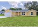 Well-kept home boasting a two-car garage, verdant lawn, and freshly painted exterior with stylish details at 14631 Se 95Th Ct, Summerfield, FL 34491