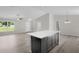 Spacious kitchen island in an open concept living space with wood floors and natural light at 14631 Se 95Th Ct, Summerfield, FL 34491